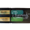 black reed guard with clarinet reeds on white background