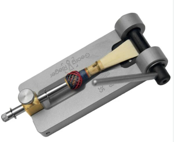 Reed tip cutter for bassoon with bassoon reed on mandrel rotary guillotine type.