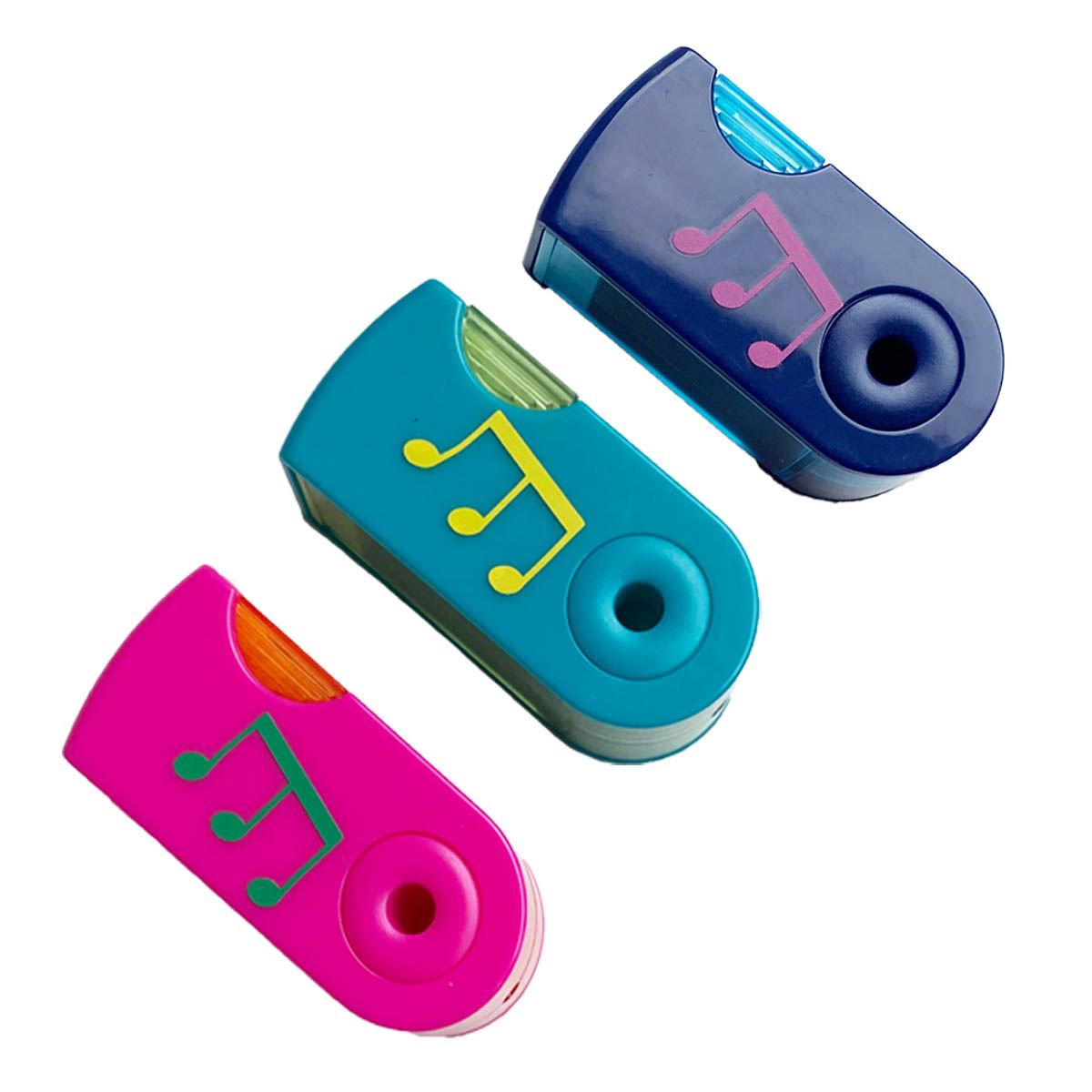 Three musical pencil sharpeners in bright colours on white background